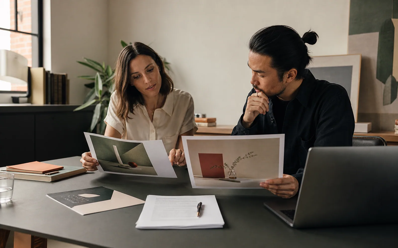 Creative team comparing advertising concepts with a written experiment plan